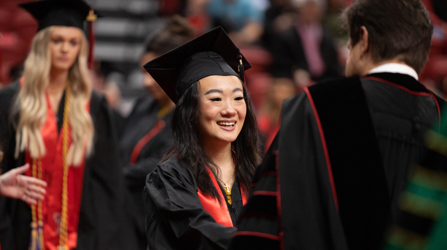 a student receiving diploma from president