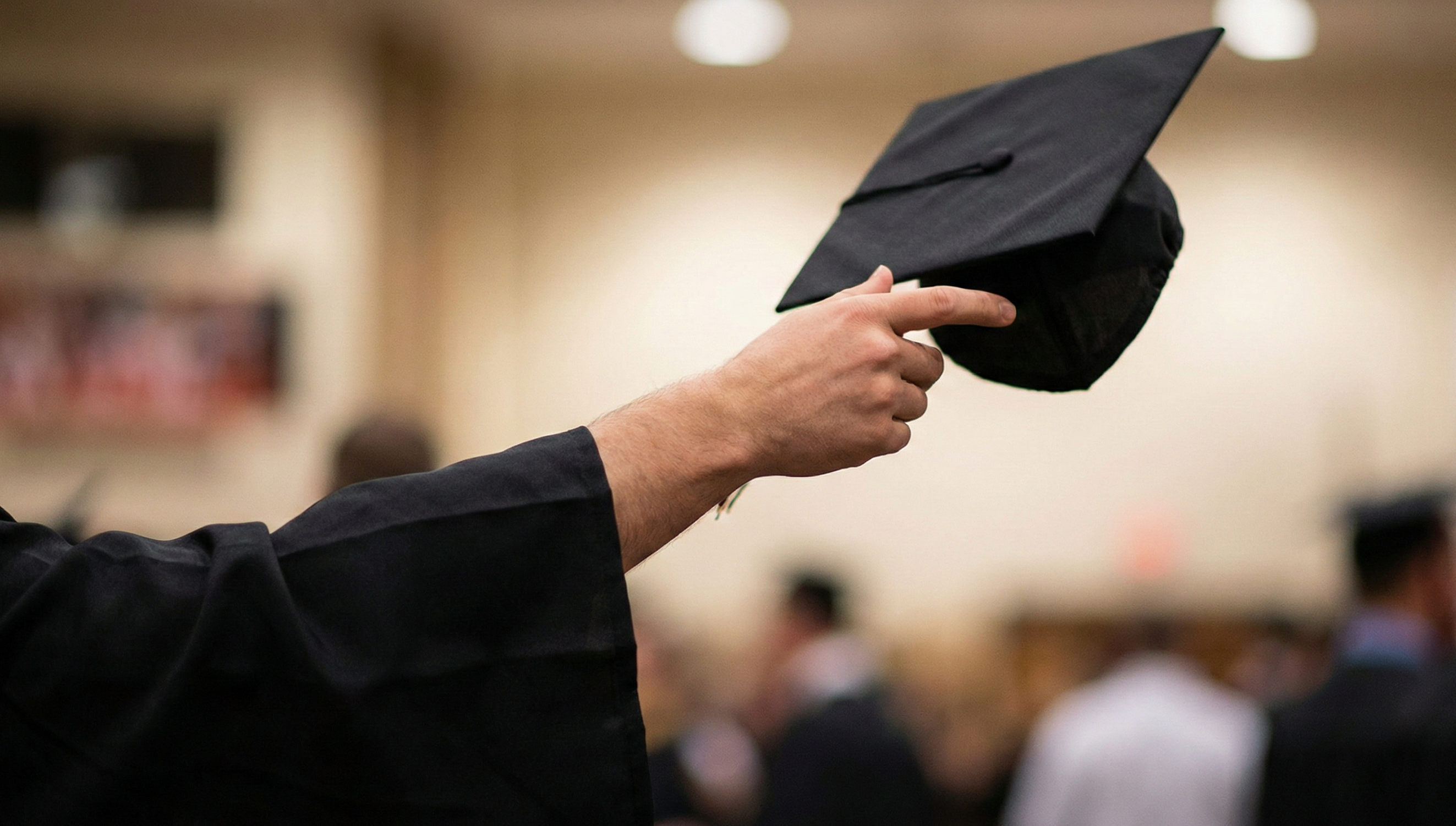 Texas Tech graduates throwing their caps in the air at commencement ceremony.