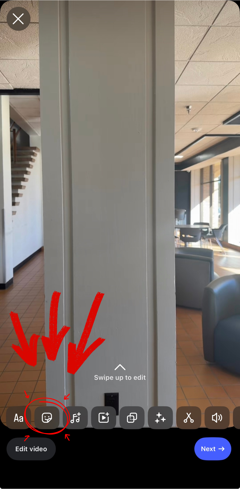 Instagram Reel editing screen. The smiley-face sticker icon is highlighted with a yellow arrow in the bottom toolbar.