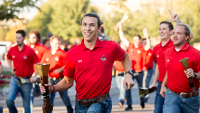 Texas Tech Saddle Tramps running with their cowbells.