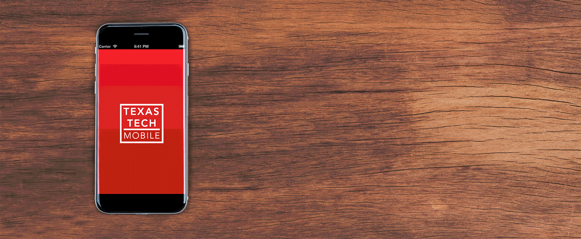 iPhone with revolving images of Texas Tech Mobile App on a wood background