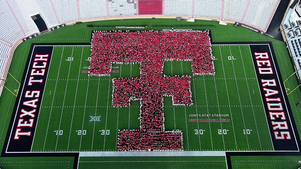 First Year Students form a Double T on the 50 yard line of Jones ATandT Stadium