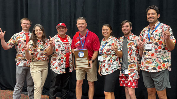 MPA students Max Fisher, Virginia Finster, Christopher Garza, Kacey Galata, Kristofer Swan and Diego Hernandez pose with coach Jeffrey Snyder (center) and the Intercollegiate Bowl trophy. 