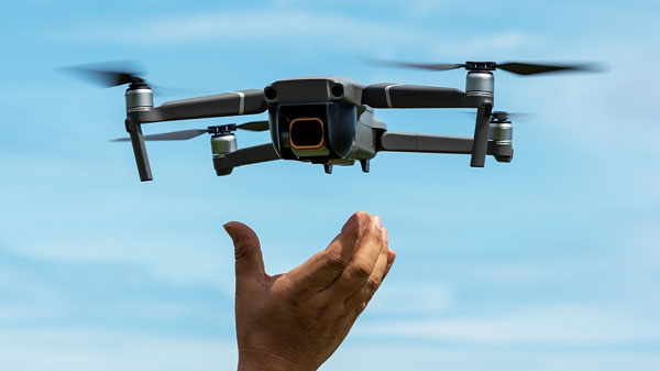 hand releasing drone into the sky