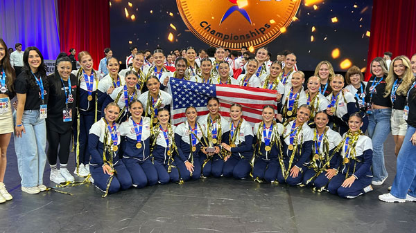 Texas Tech pom squad celebrates with gold medals and an American flag on stage