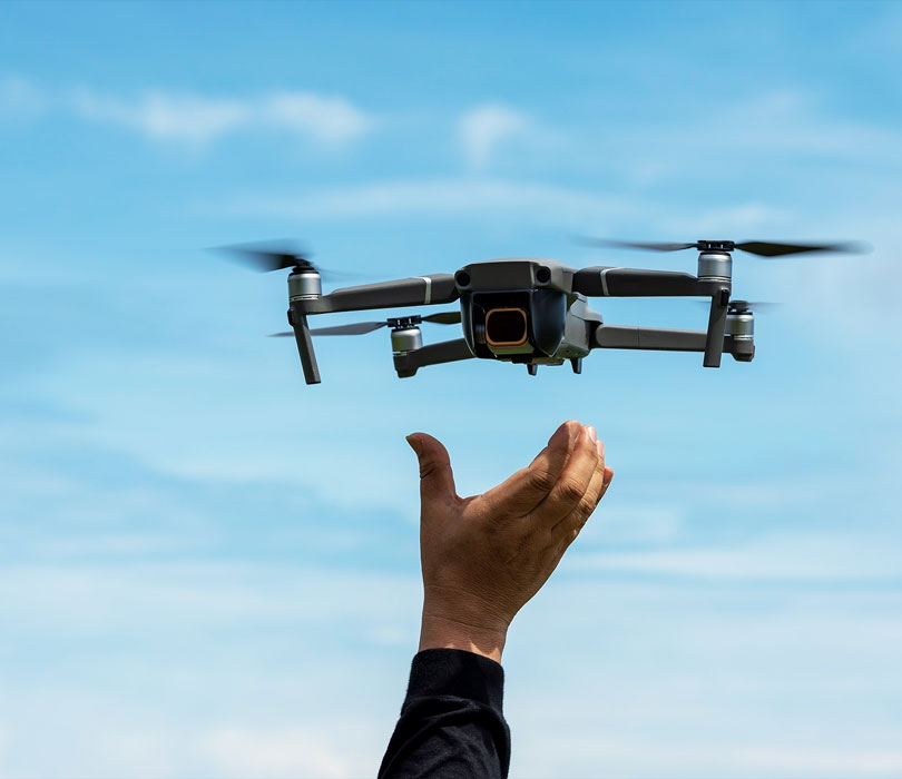 hand releasing drone into the sky