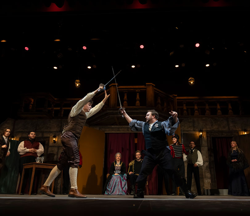 Hamlet: sword fight on stage as other actors look on