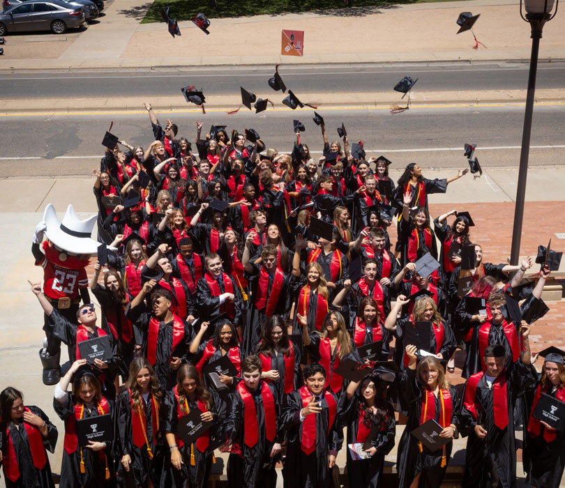 graduates tossing hats
