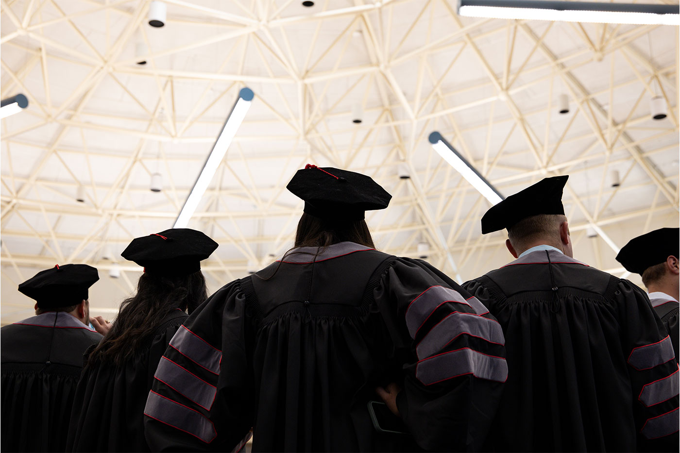 View of 5 graduates from behind and below.