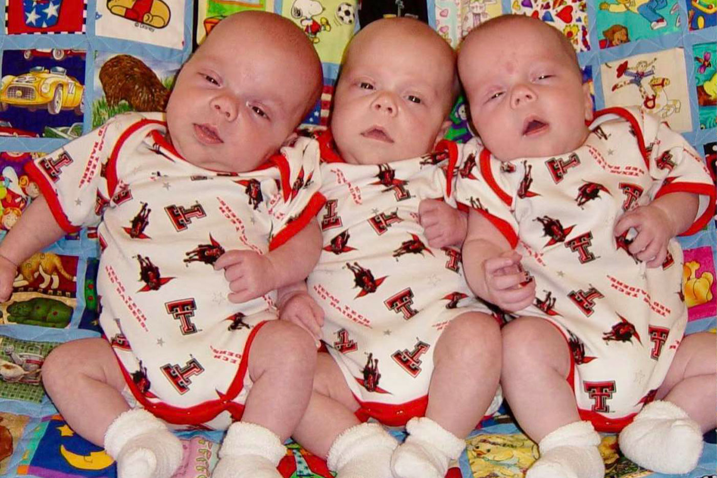 Truman, Cate and Ava dressed in Texas Tech onesies