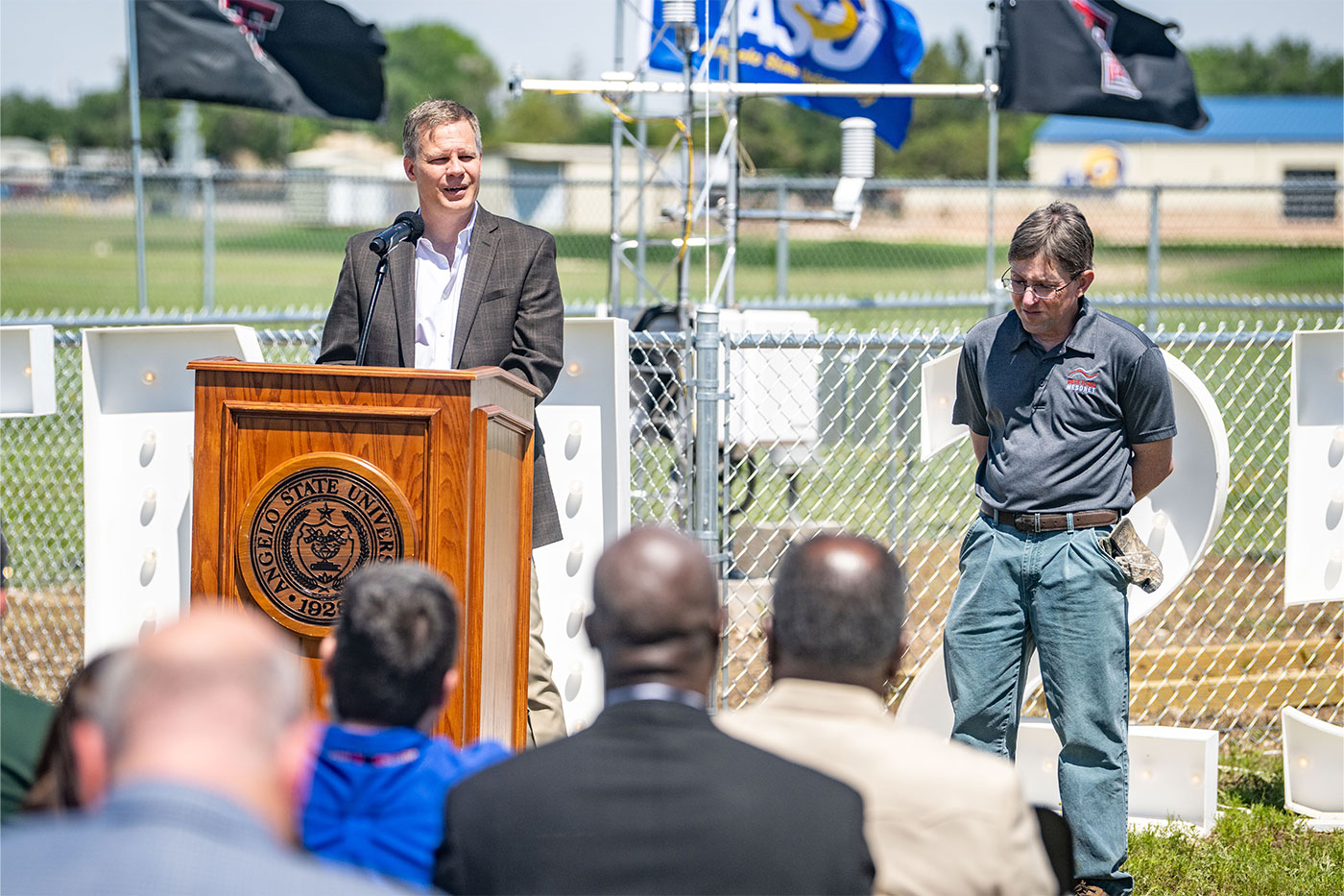 John Schroeder takes the podium, as Network Manager Wes Burgett looks on.