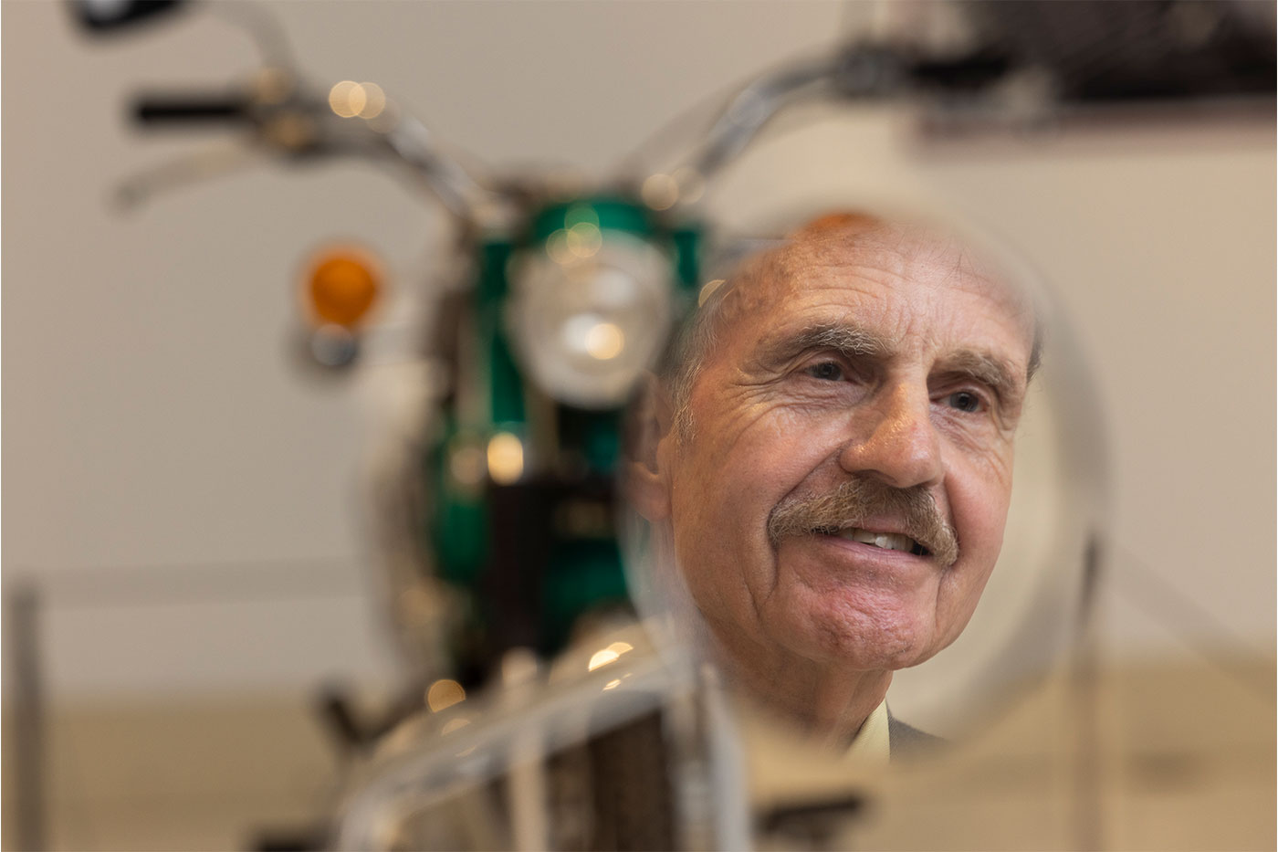 John Cain looking at a motorcycle.