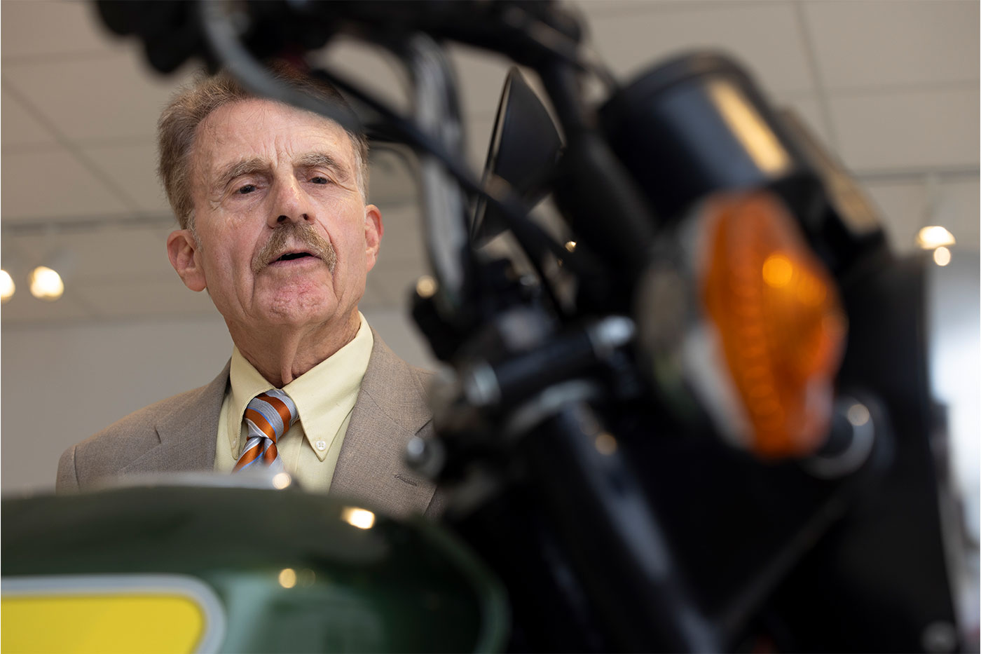 John Cain looking at a motorcycle.
