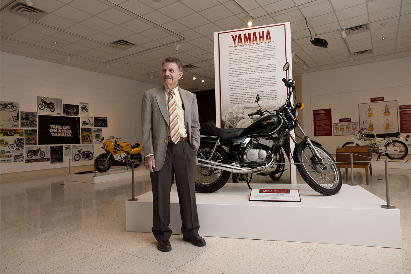 John Cain standing on the floor of his exhibit.