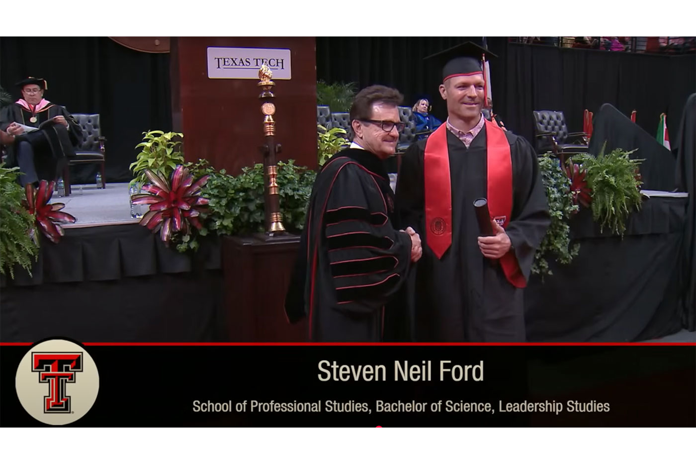 Steven shakes the hand of President Schovanec