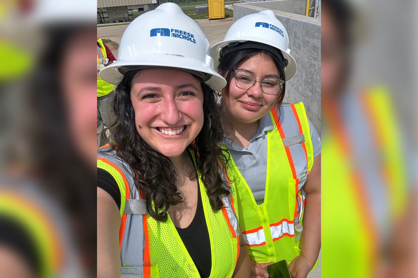 two females in reflective vests