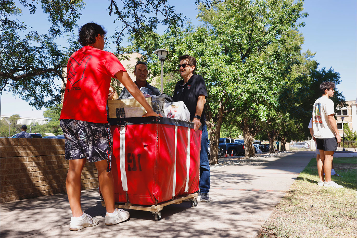 President Lawrence Schovanec assists a student moving in to a residence hall.