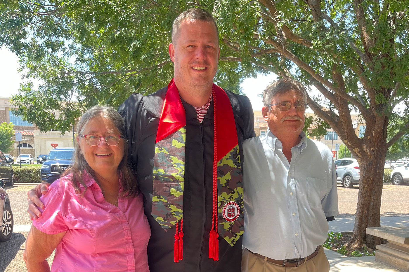 Greg’s graduation, celebrating with his mom and stepdad, Angie and Jeff.