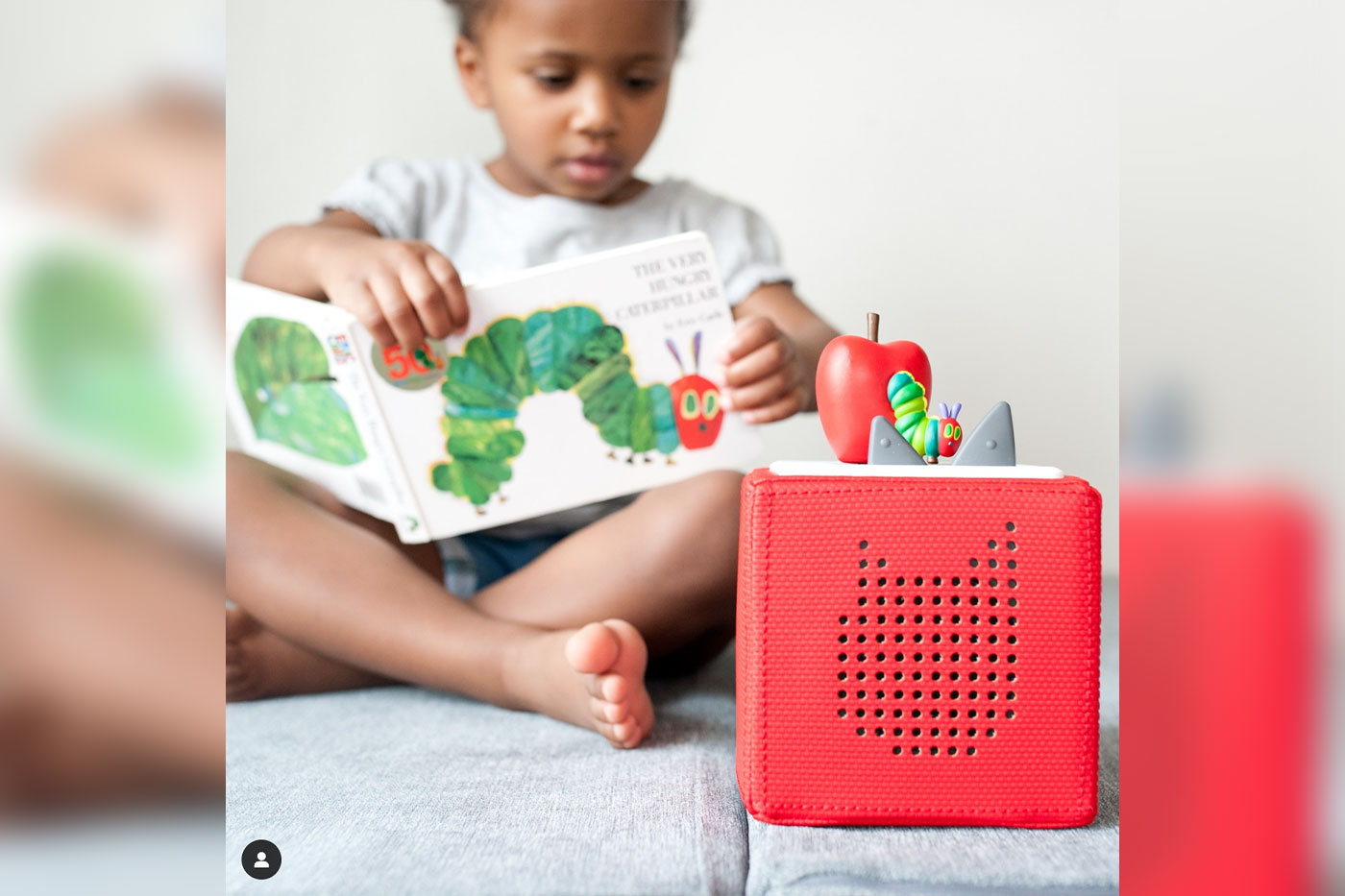 Toddler sitting with a Toniebox