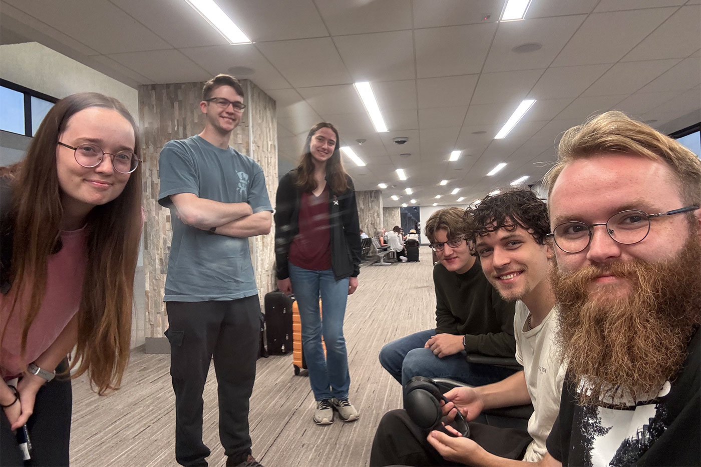 Caitlin Tidmore (far left), Harry Brittan, Elizabeth Veraa, Michael O’Donnell, Miles Harris and Xander Delashaw gather at the airport for their trip to CERN.