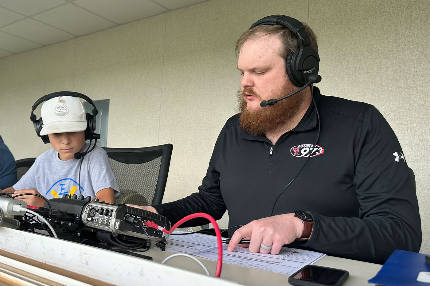 Brayden Tomlinson with another sportscaster from 97.3 FM