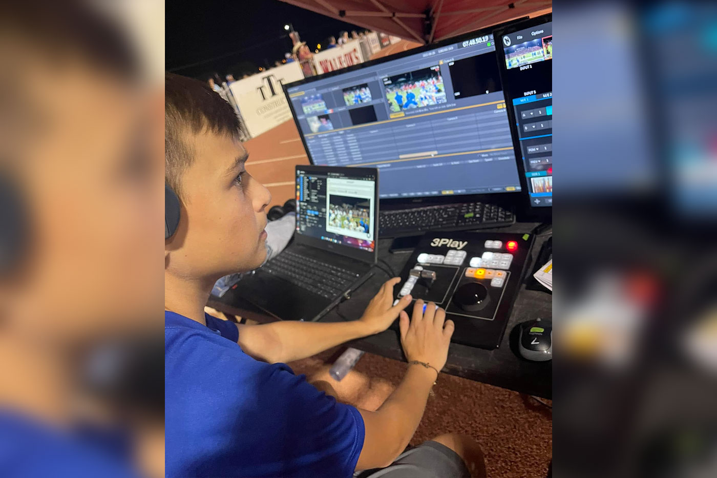 Brayden Tomlinson working with audio equipment. 