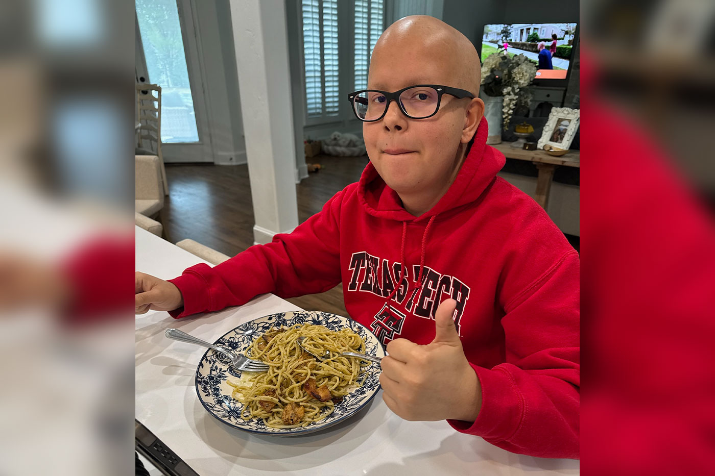 Aaron eating a bowl of pasta. 