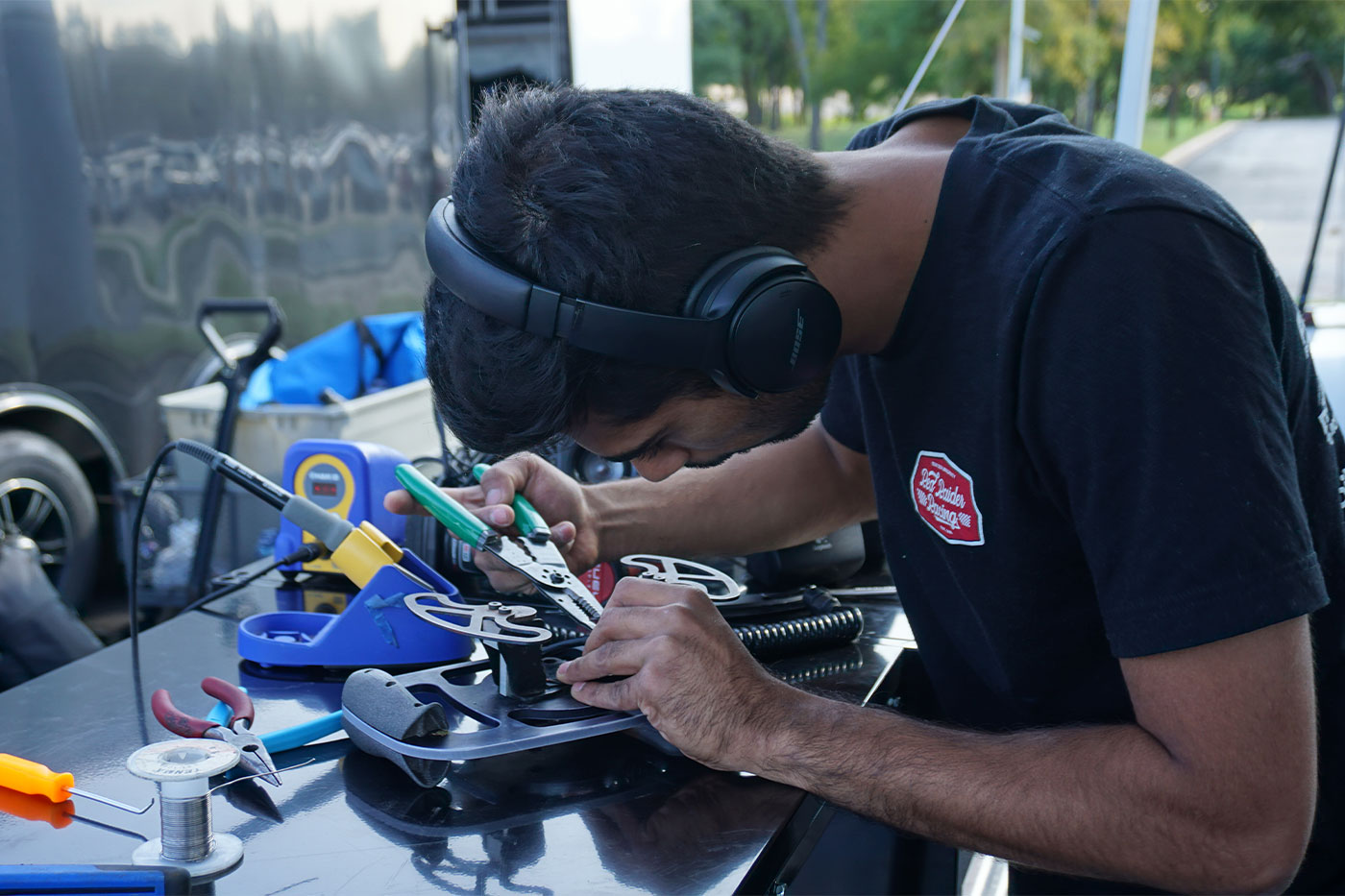 Student using a soldering iron. 