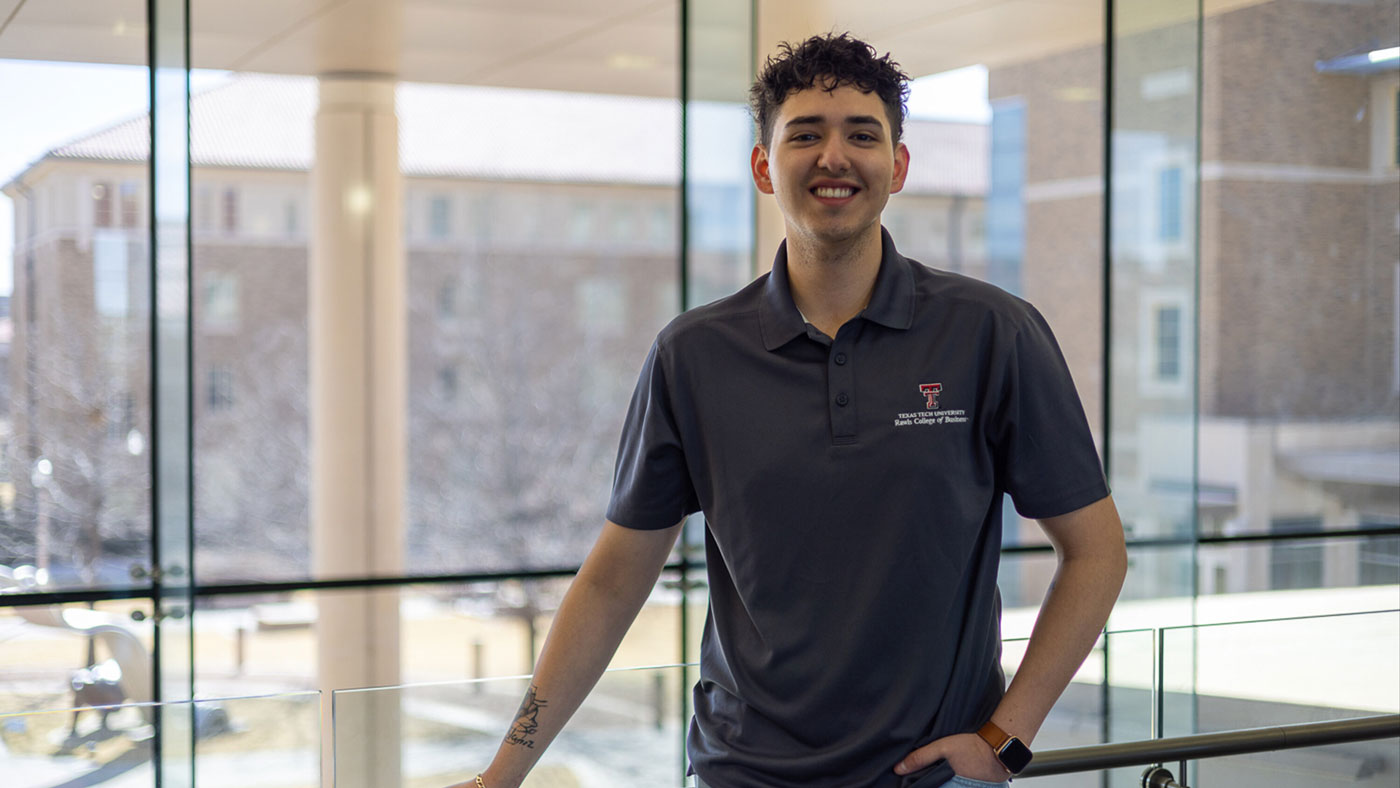 Roque wearing a Rawls College of Business shirt. 