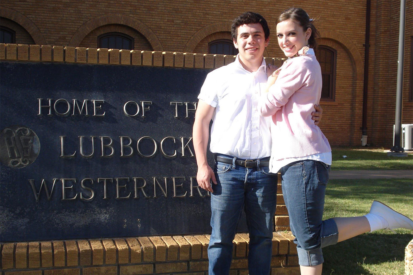 Josh and Gini in front of the Lubbock High School sign. 