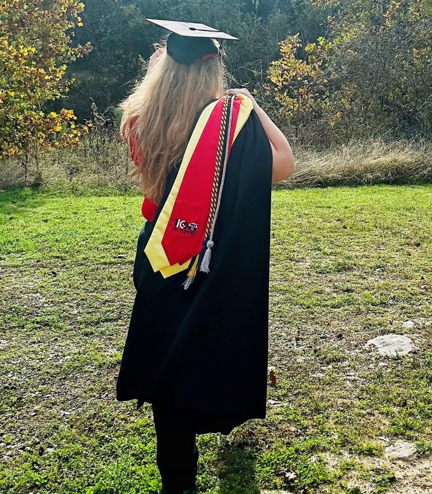 Casey puts on her mortar board as she walks away.