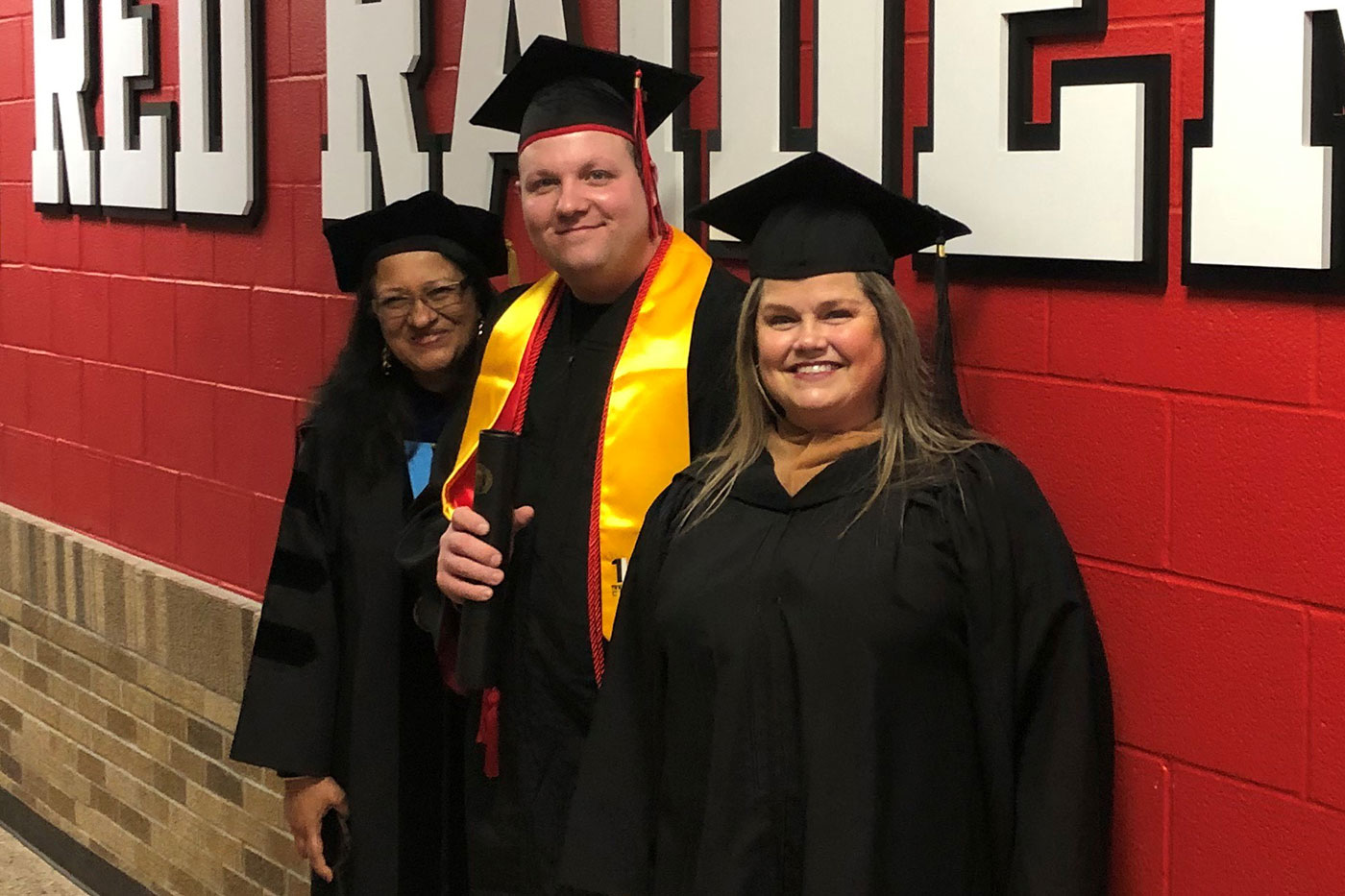 Morgan Provost, foreground, with Jeramiah and another of his lecturers, Sipra Nath Eko, at commencement.