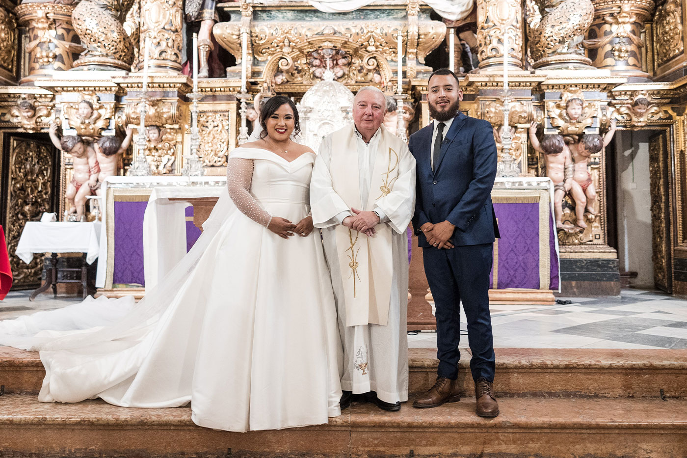 Norma and Frankie with a priest on their wedding day. 