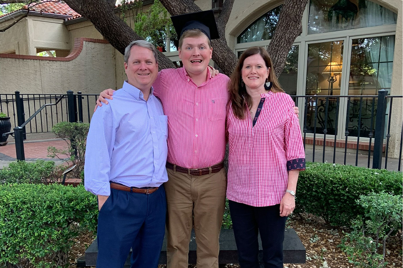 Jackson with his parents at his graduation