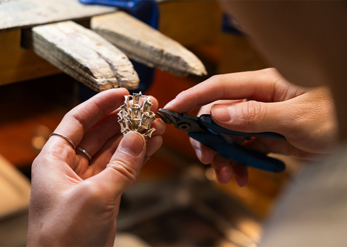 Hands trimming a gem