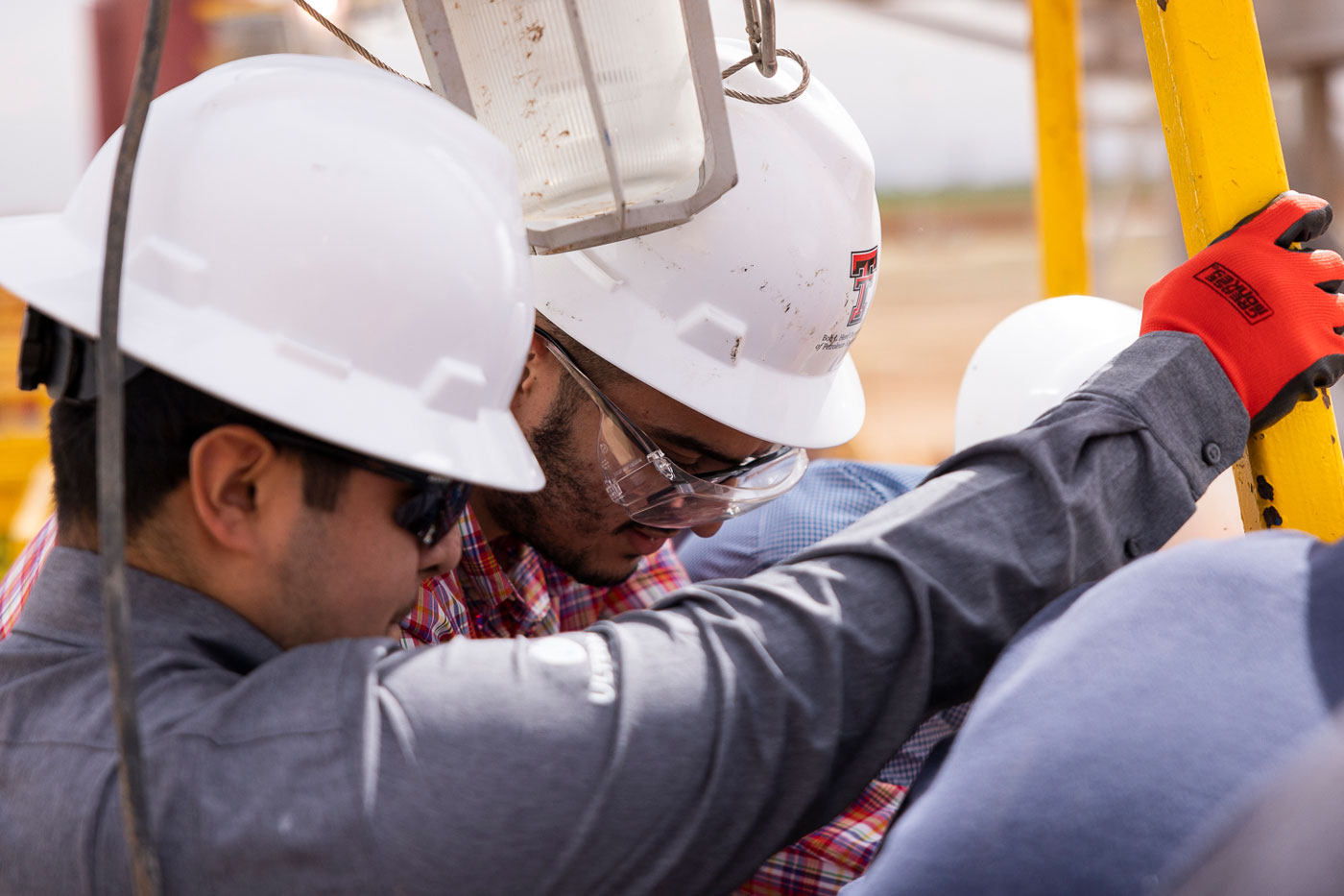 people working on oil well drilling rig