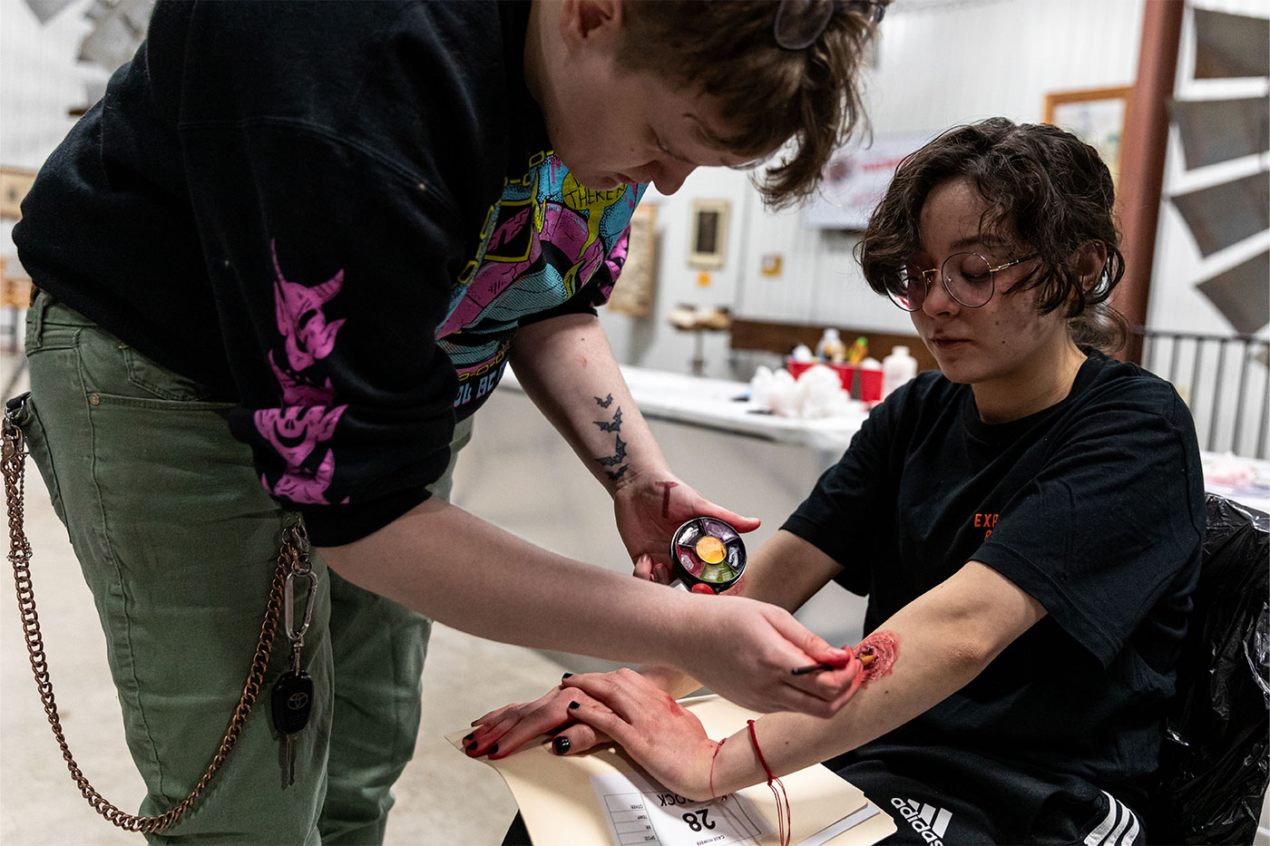 Applying moulage to a student's arm. 