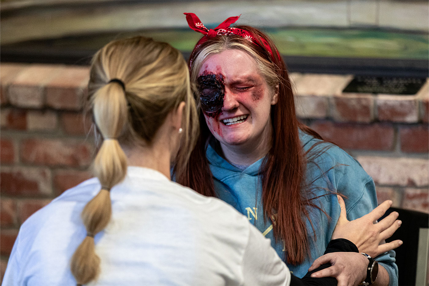Theatre student with critical eye wound acting in simulation