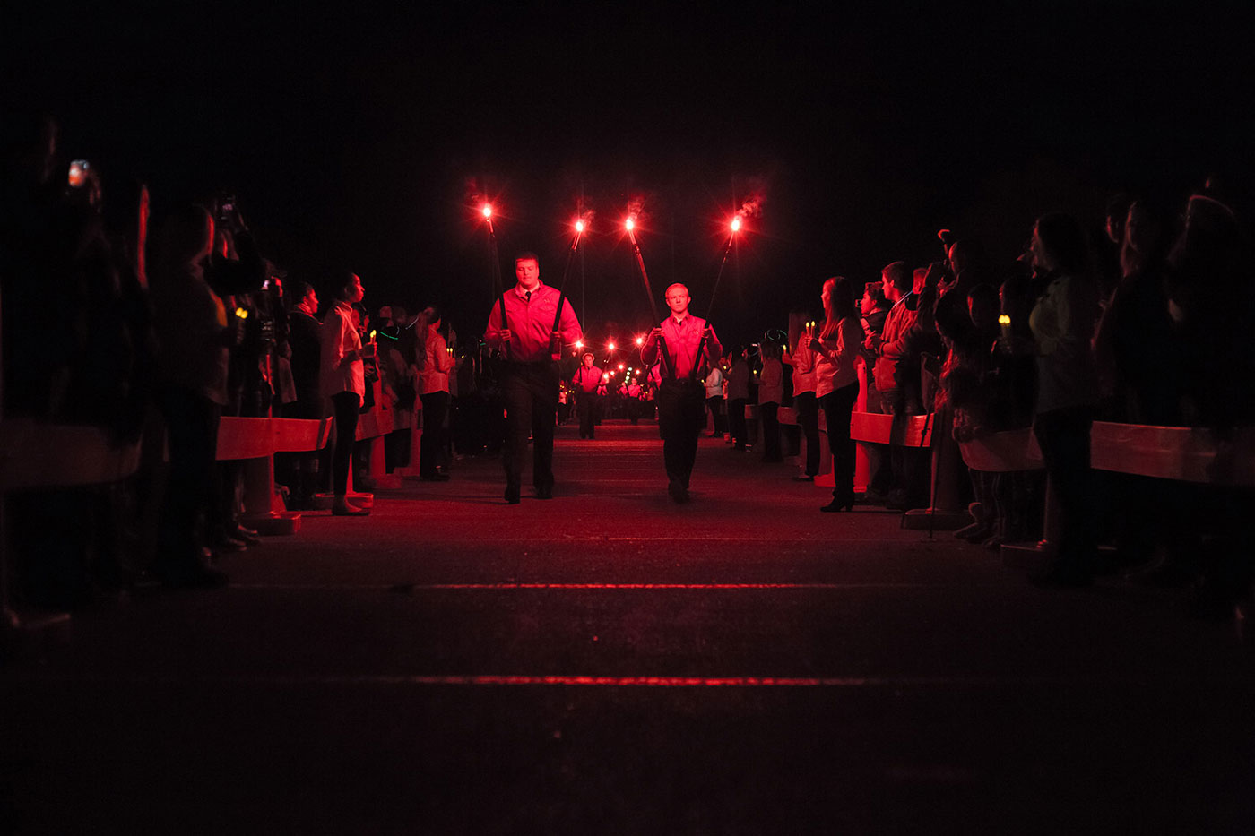 Saddle Tramps carrying red glowing torches. 