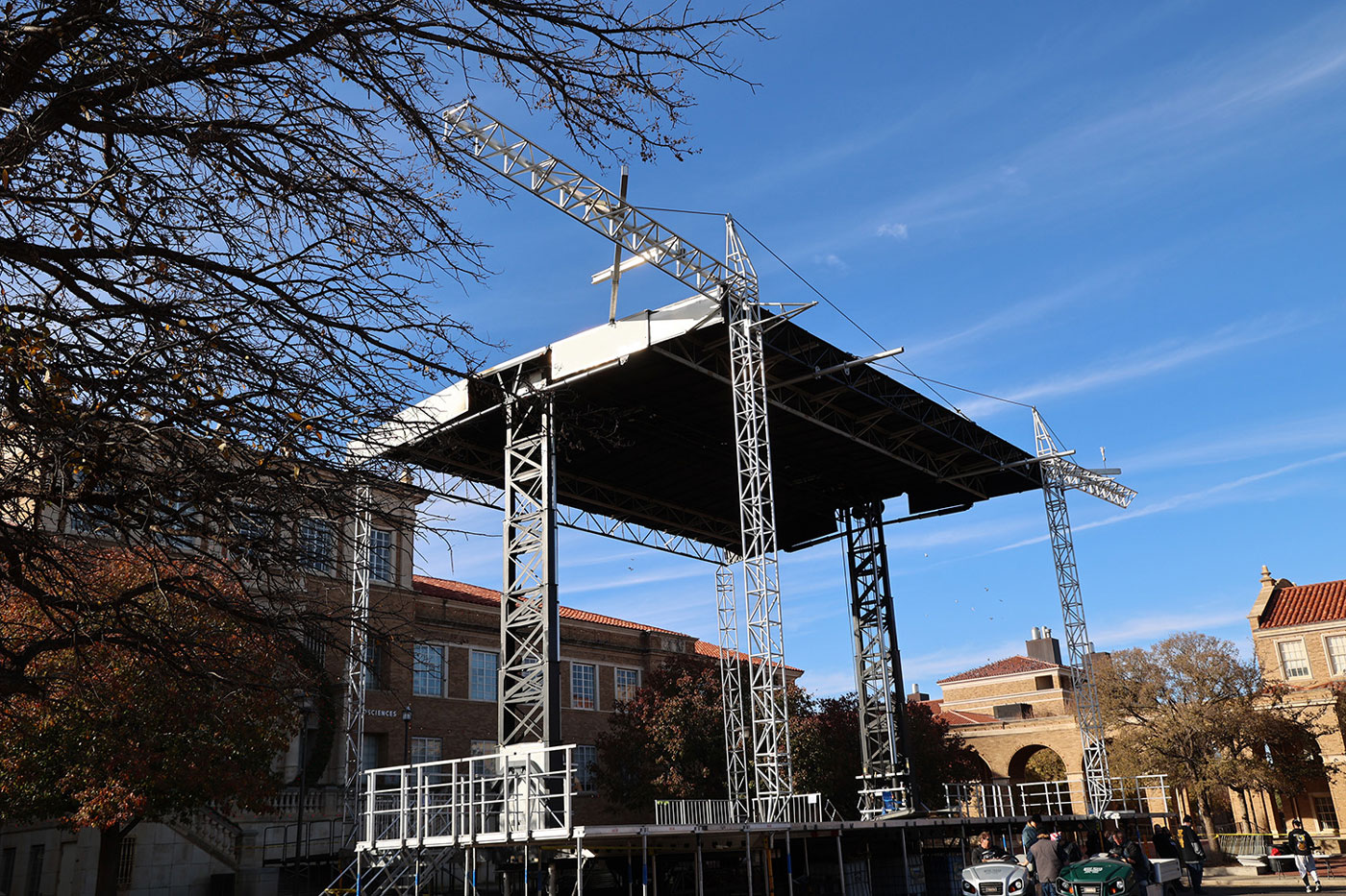Workers erecting a stage. 