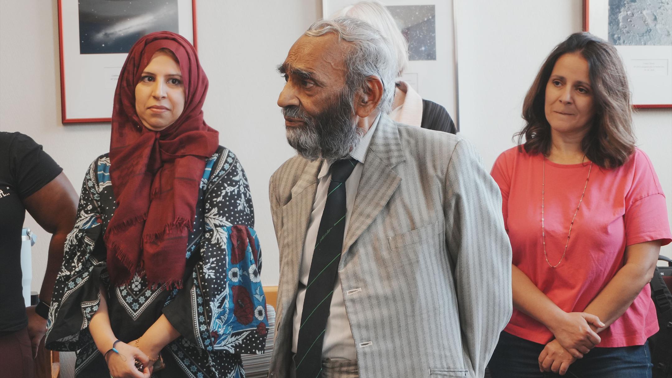 Dr. Arfin Lodhi  and colleagues in a room