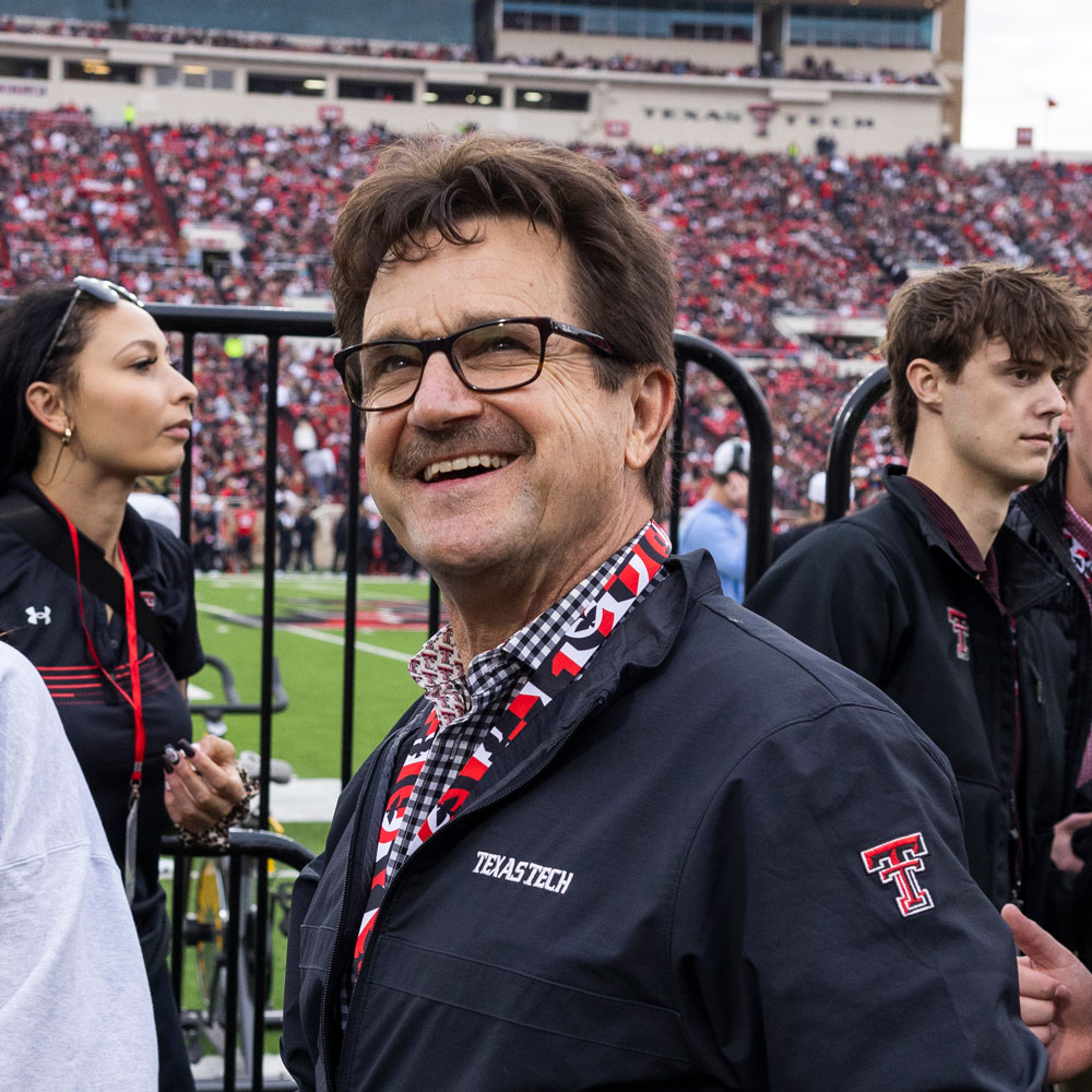 President Lawrence Schovanec smiling at the football crowd