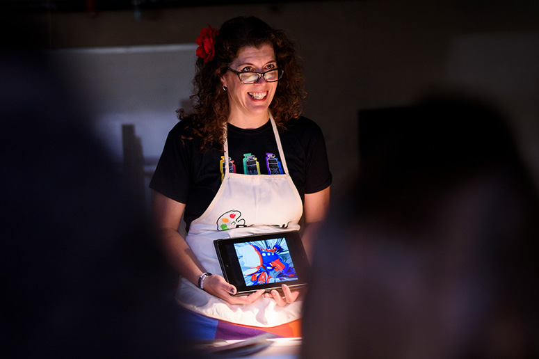 Teacher showing artwork using an iPad.