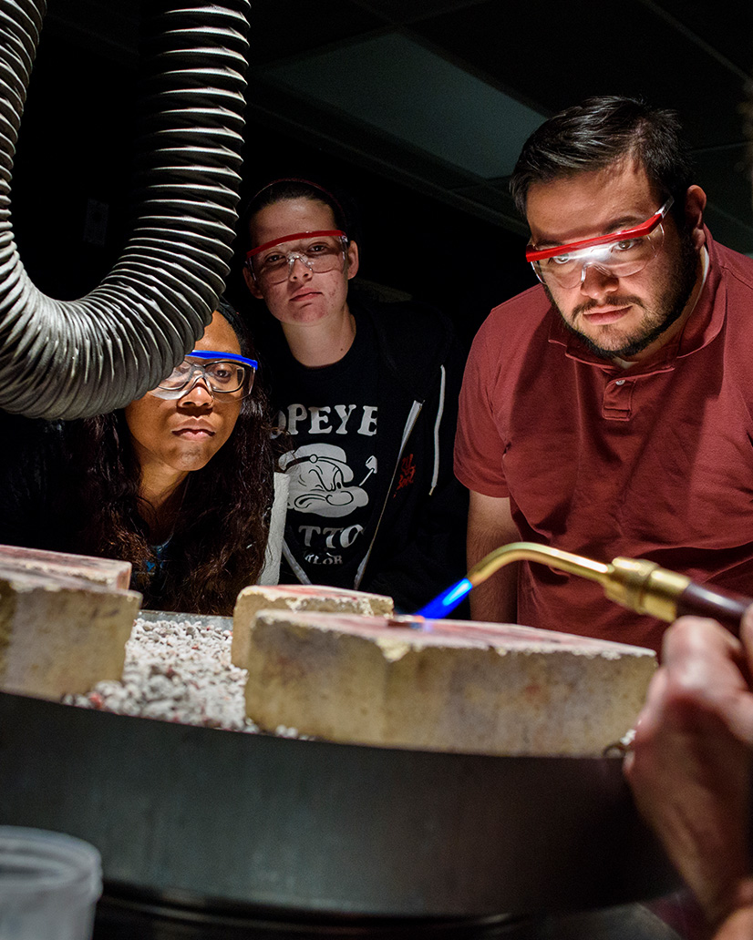 Group of students working in metals lab.