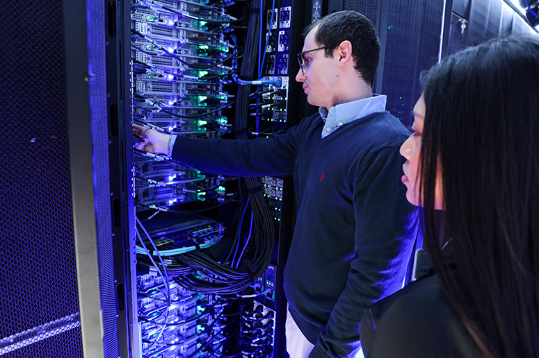 Students investigate wiring on servers.