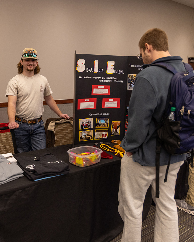 Sigma Iota Epsilon member at a student org fair.