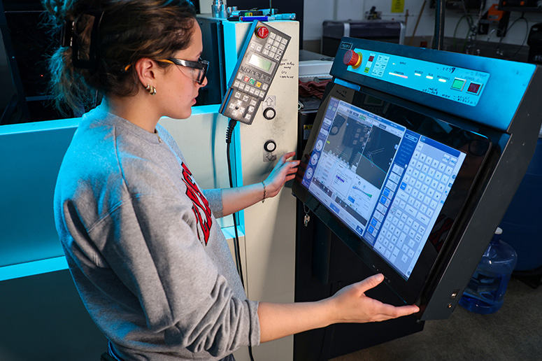 Student at large machinery workstation.
