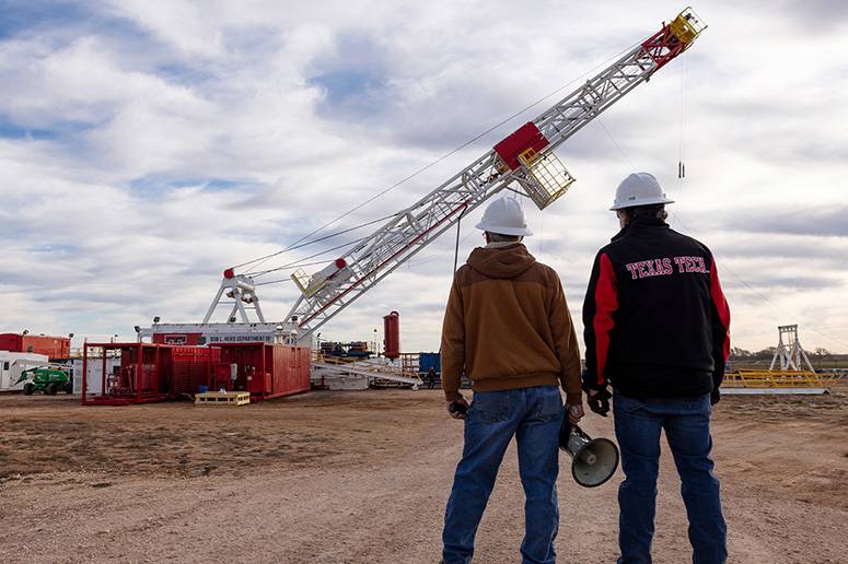 Engineers watching the construction of an oil rig.