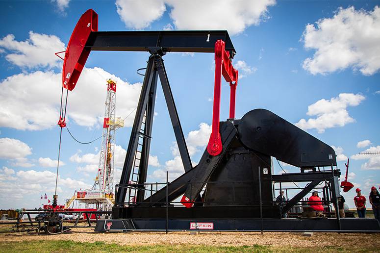 A pumpjack and an oil rig at The Oilfield Technology Center at the College of Engineering.