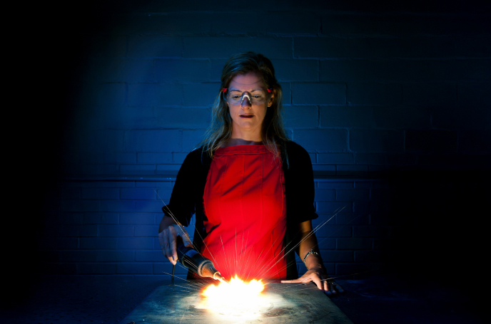 Three students examining and discussing.